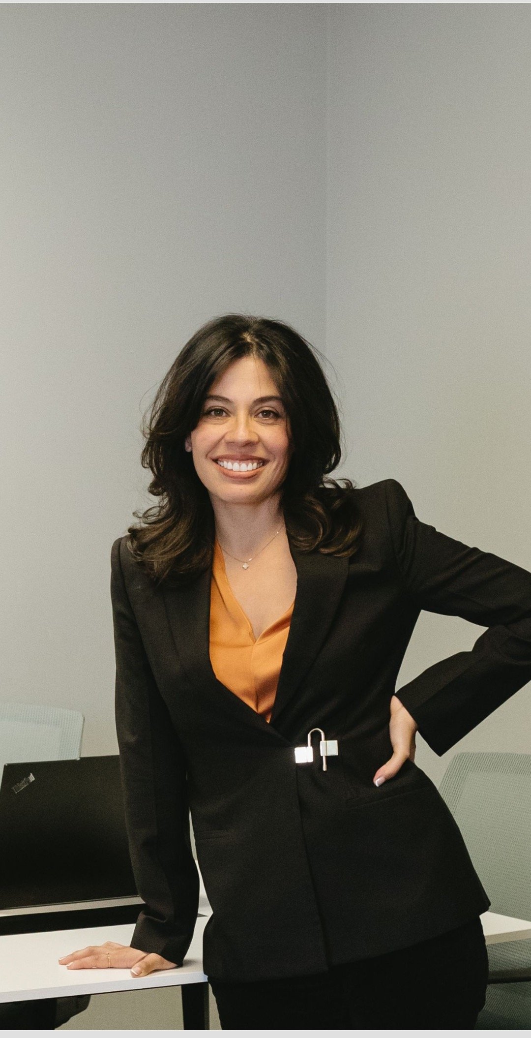 Brenda Echevarria standing at her desk